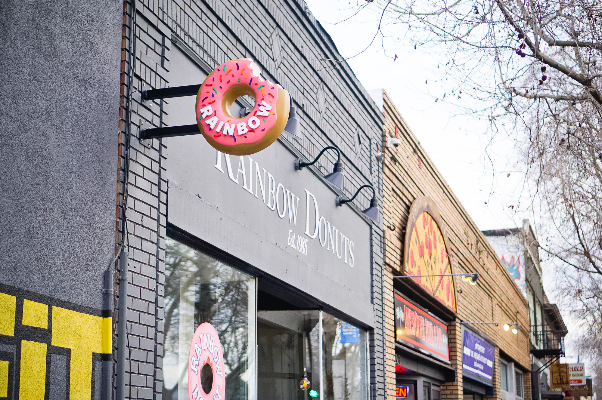 3D, pink-frosted, sculptural, sprinkle donut blade sign for Rainbow Donuts in Berkeley, CA 3D, pink-frosted, sculptural, sprinkle donut blade sign for Rainbow Donuts in Berkeley, CA