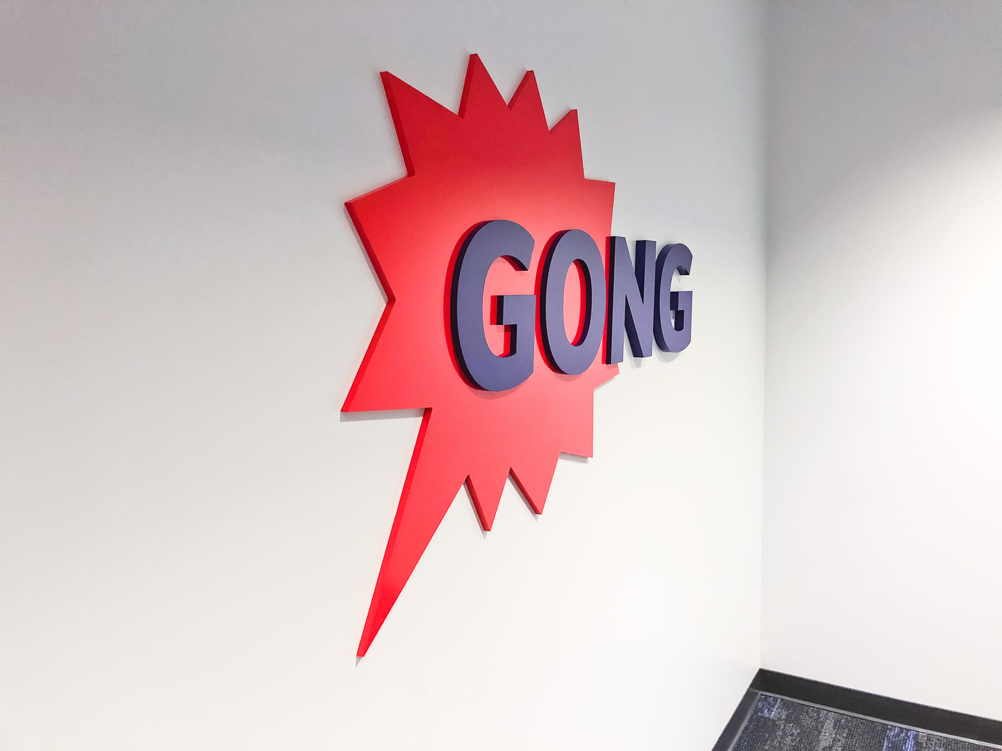 Red and purple painted sign for the San Francisco office of Gong, makers of a conversation intelligence platform for sales. Red and purple painted sign for the San Francisco office of Gong, makers of a conversation intelligence platform for sales.