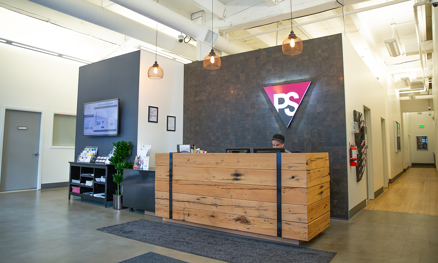 Illuminated pink and grey entrance sign for Peer Seattle, a gay and lesbian organization in Seattle, Washington Illuminated pink and grey entrance sign for Peer Seattle, a gay and lesbian organization in Seattle, Washington