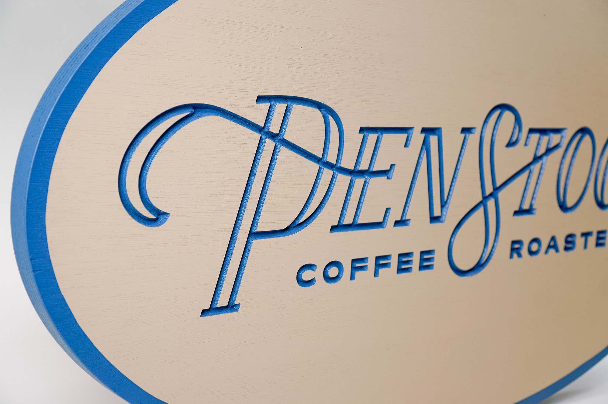 Blue and light wood engraved sign for Penstock Coffee Roasters, a coffee roastery and specialty coffee shop in New Jersey. Blue and light wood engraved sign for Penstock Coffee Roasters, a coffee roastery and specialty coffee shop in New Jersey.