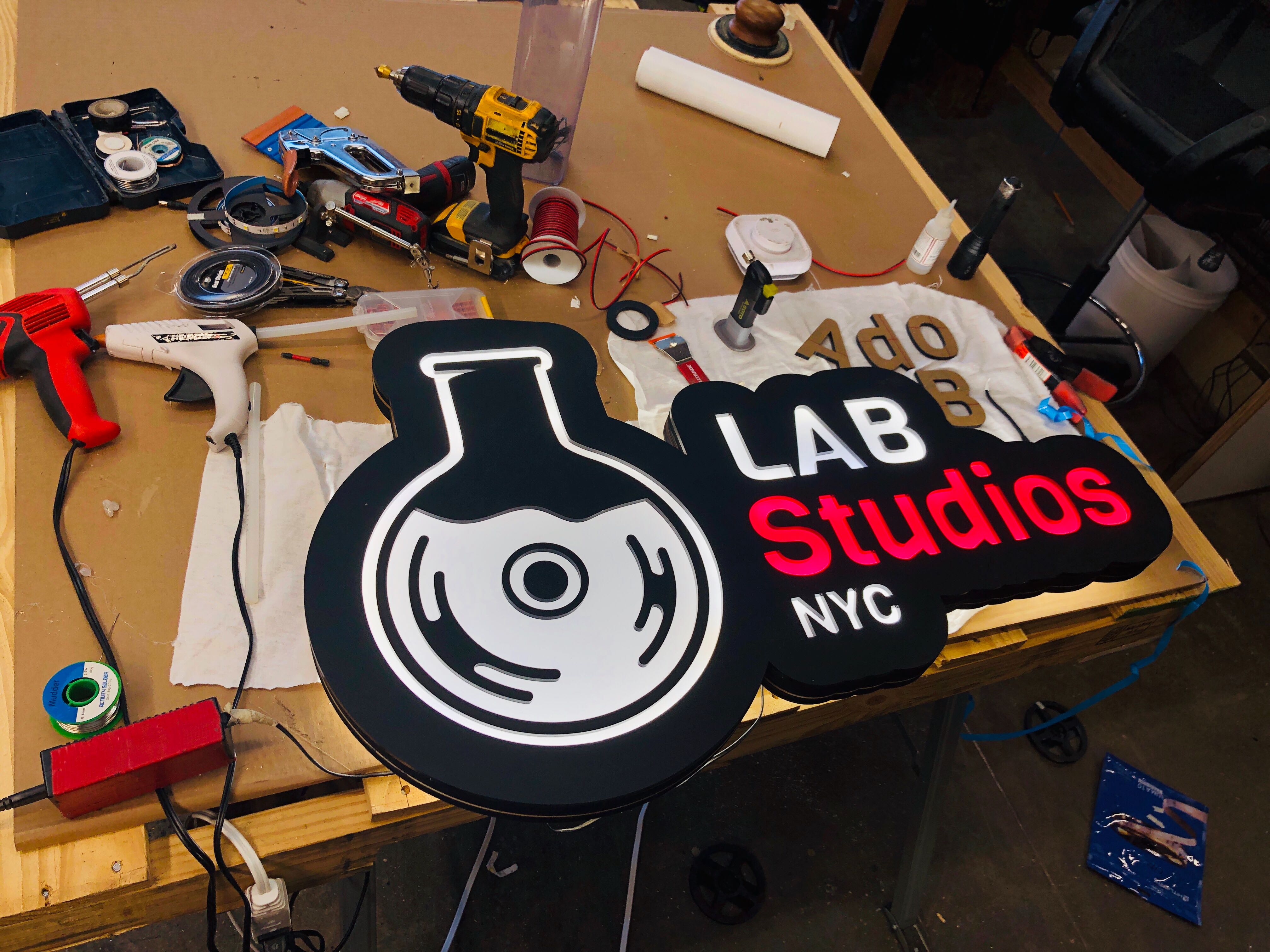 Lab Studios illuminated sign on workbench