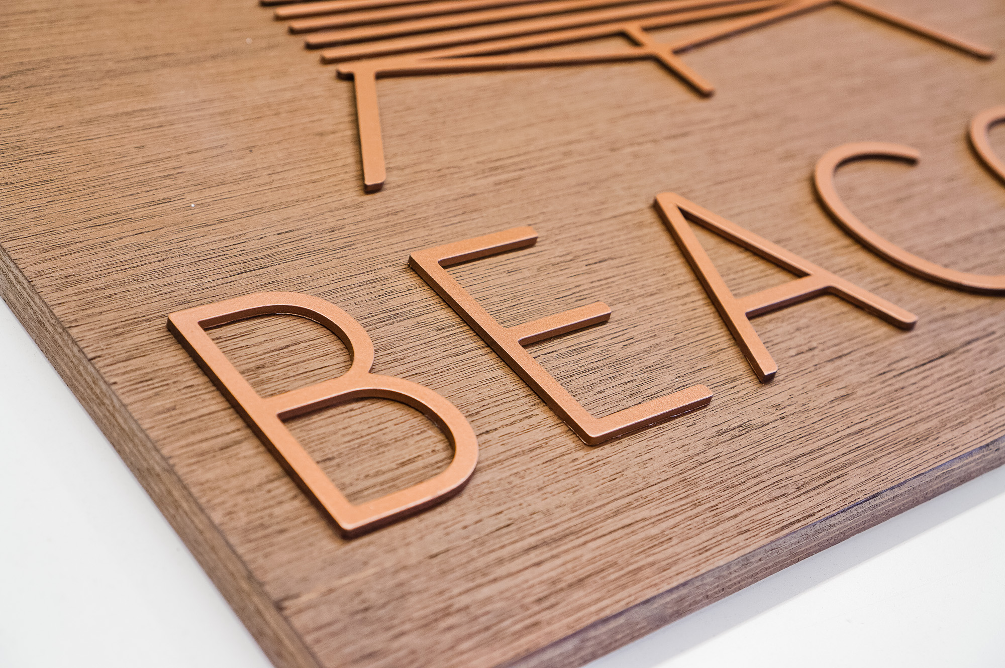 Metallic copper painted acrylic and dark wood outdoor sign for Beacon Metallic copper painted acrylic and dark wood outdoor sign for Beacon