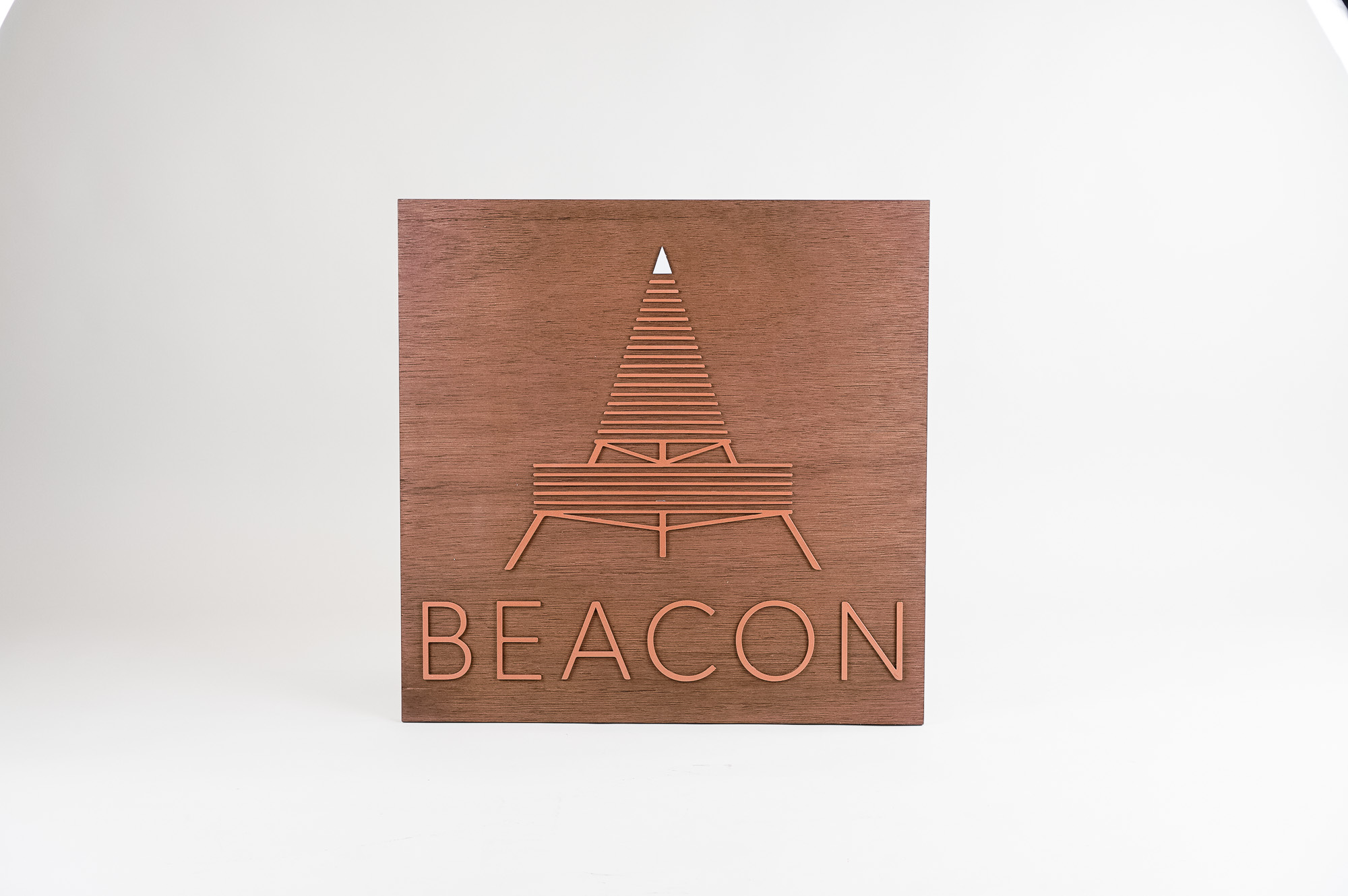 Metallic copper painted acrylic and dark wood outdoor sign for Beacon Metallic copper painted acrylic and dark wood outdoor sign for Beacon