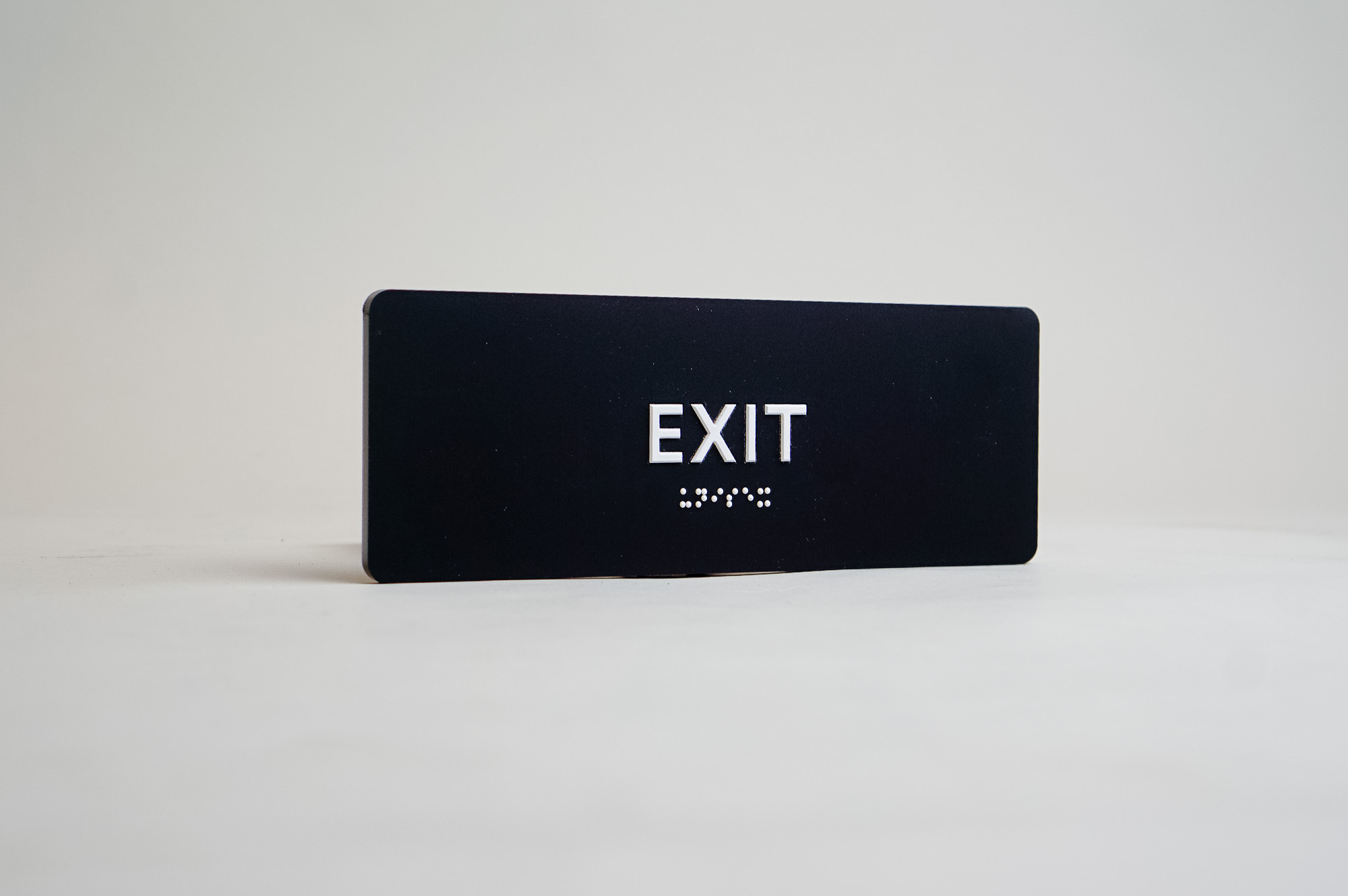 Modern black and white ADA exit sign
