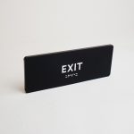 Modern black and white ADA exit sign