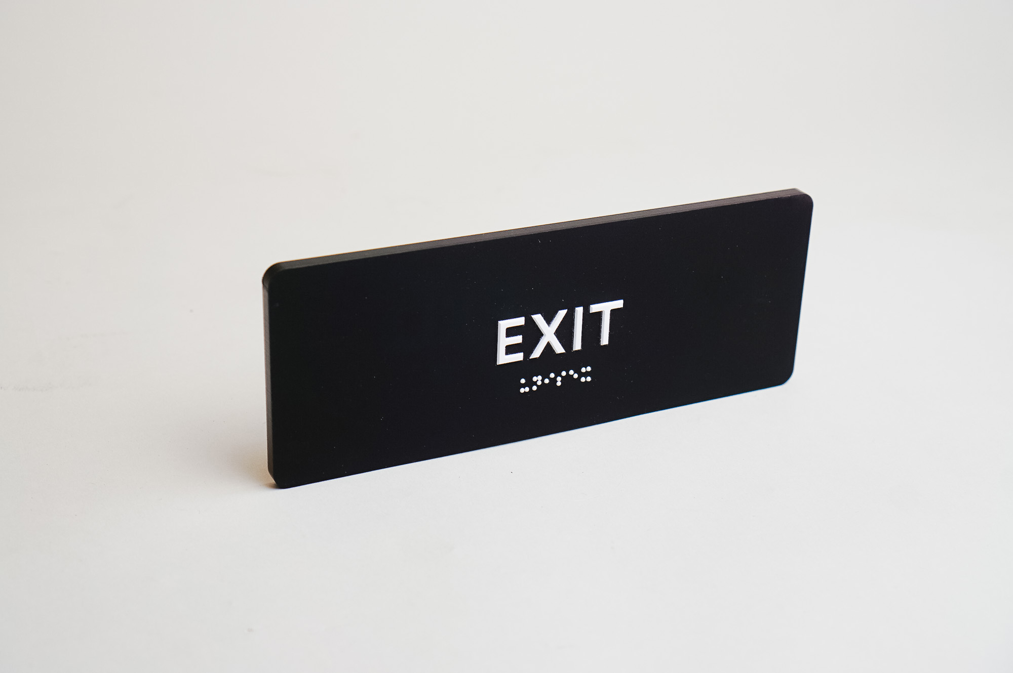 Modern black and white ADA exit sign