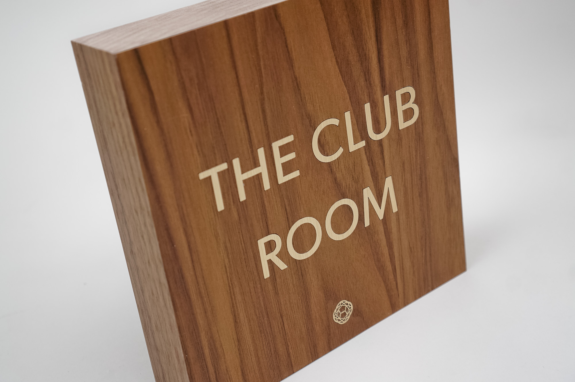 Vintage walnut and inlaid-brass style sign for Nexus Club, a private social and business club in New York.