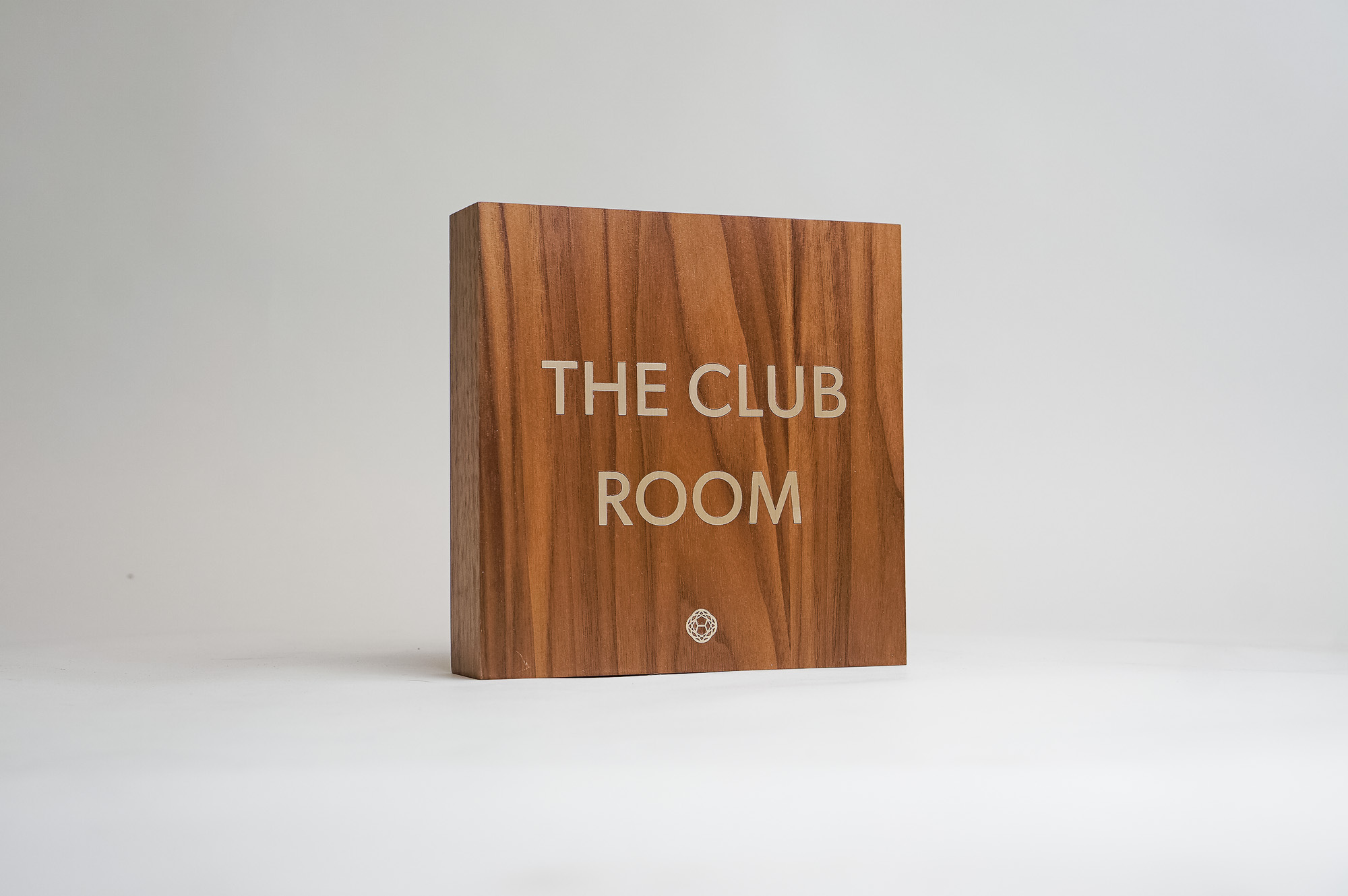 Vintage walnut and inlaid-brass style sign for Nexus Club, a private social and business club in New York.