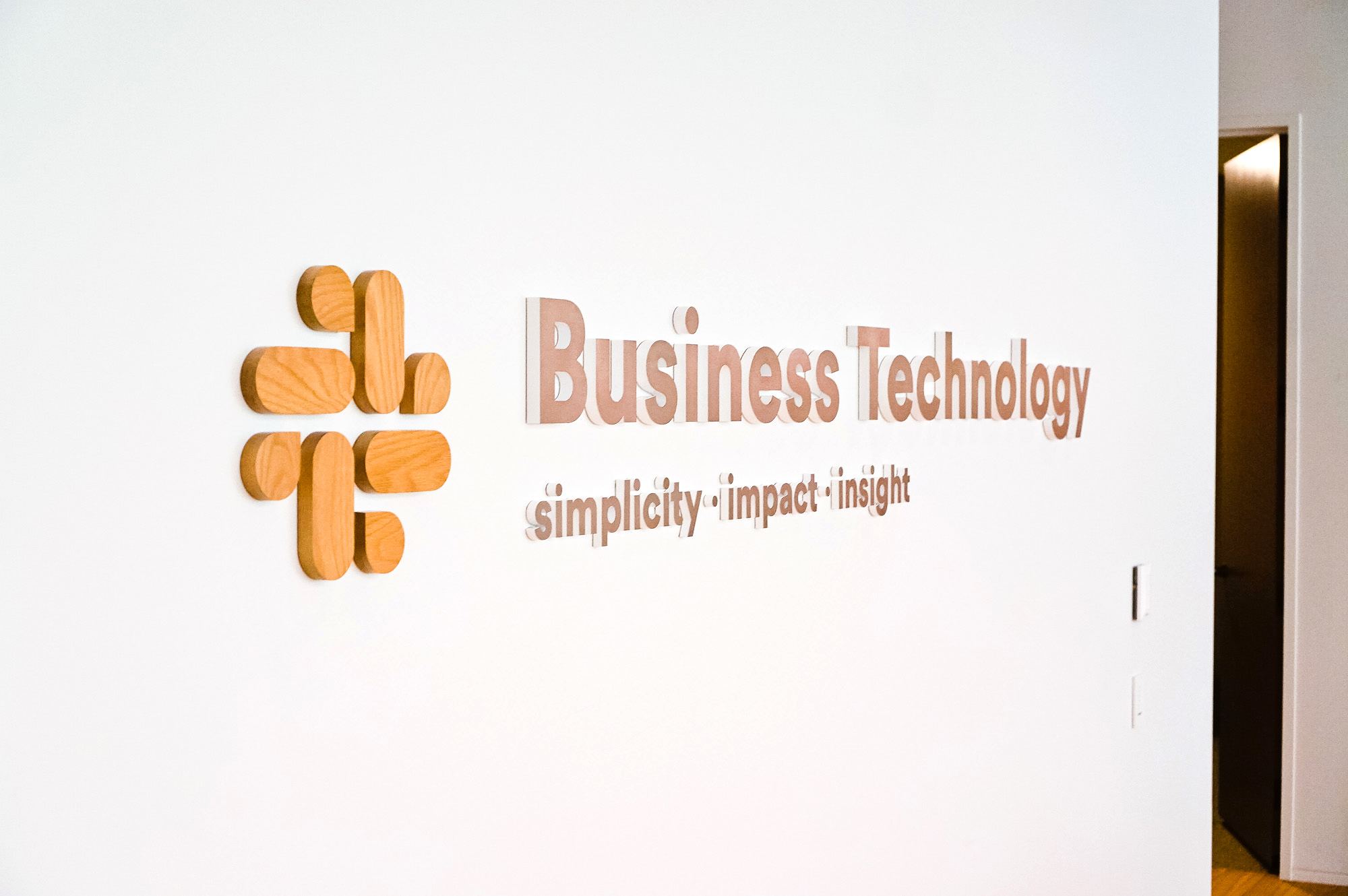 Wood and metal sign for the Business Technology department at Slack, an American cloud-based set of team collaboration tools and services. Wood and metal sign for the Business Technology department at Slack, an American cloud-based set of team collaboration tools and services.