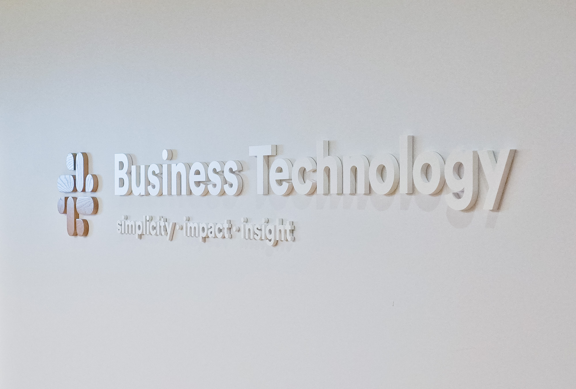 Dimensional sign with wood icon and white lettering on a white wall at the San Francisco office of Slack, an American cloud-based set of proprietary team collaboration tools and services. Dimensional sign with wood icon and white lettering on a white wall at the San Francisco office of Slack, an American cloud-based set of proprietary team collaboration tools and services.