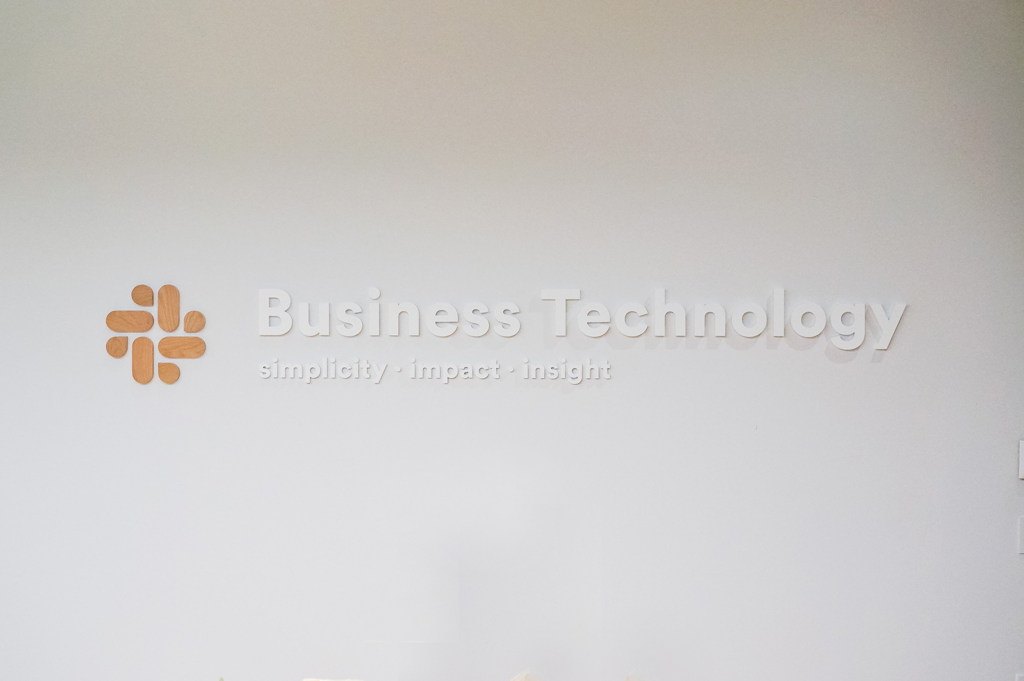 Dimensional sign with wood icon and white lettering on a white wall at the San Francisco office of Slack, an American cloud-based set of proprietary team collaboration tools and services. Dimensional sign with wood icon and white lettering on a white wall at the San Francisco office of Slack, an American cloud-based set of proprietary team collaboration tools and services.