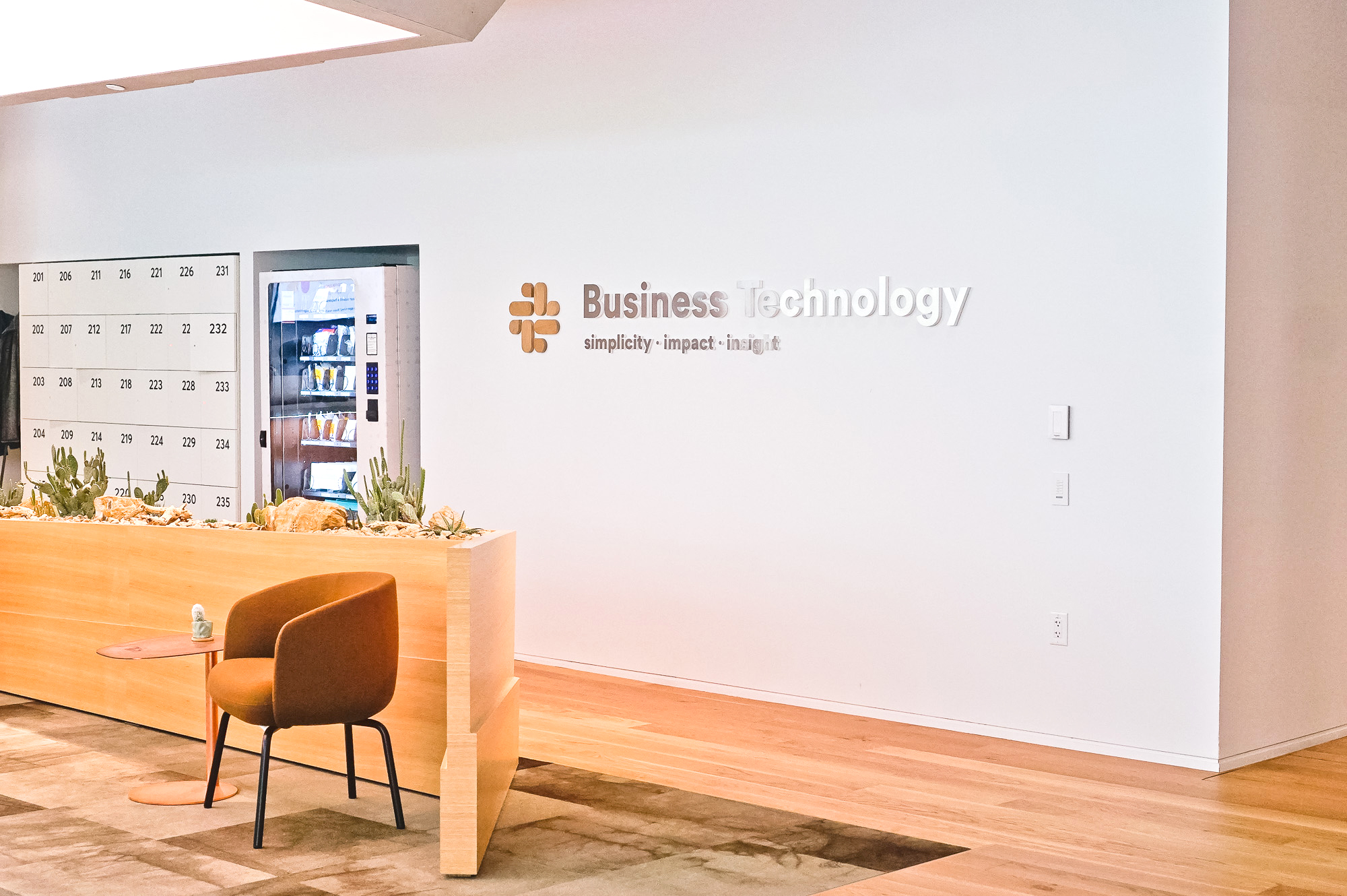 Wood and metal sign for the Business Technology department at Slack, an American cloud-based set of team collaboration tools and services.