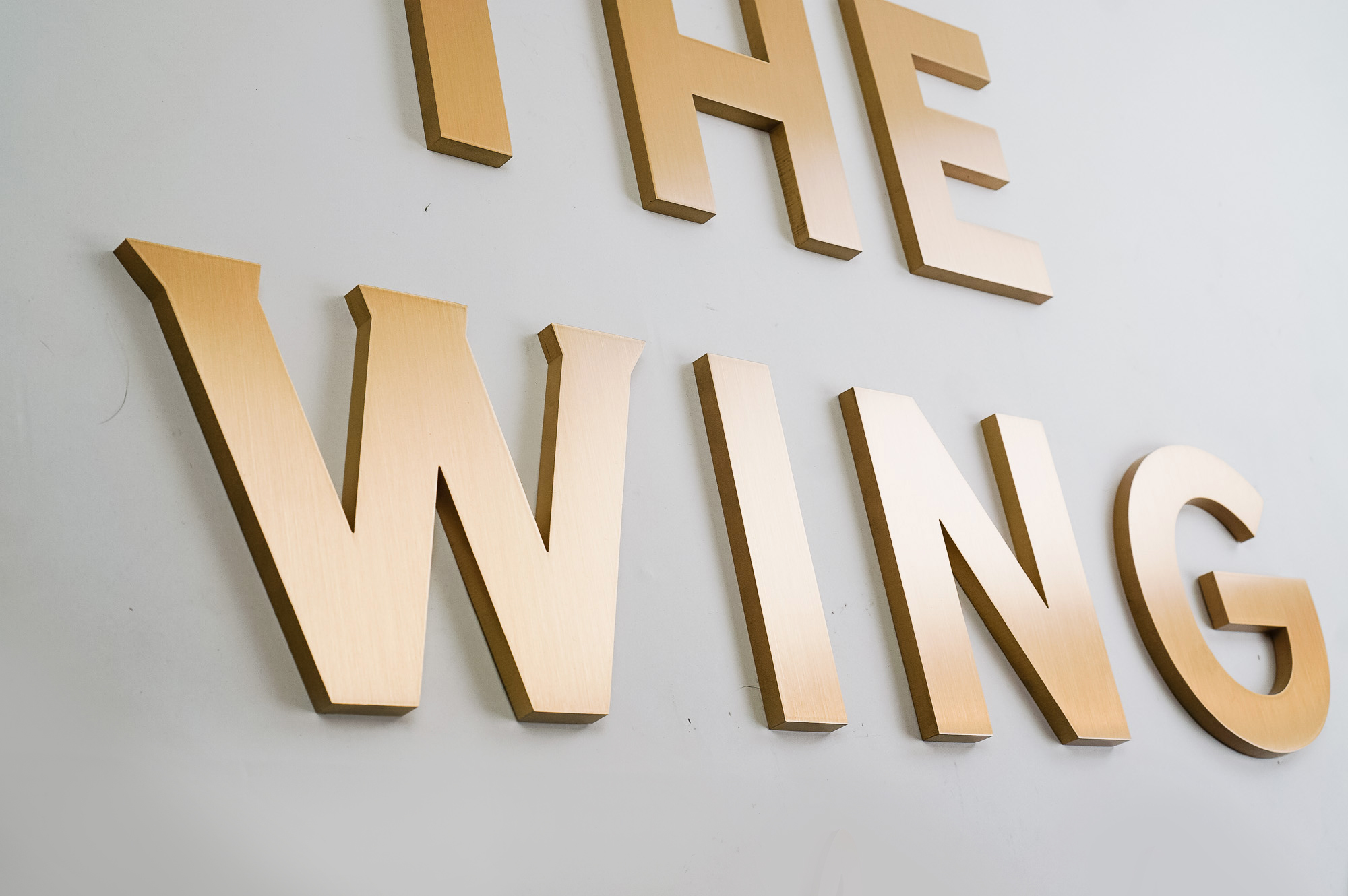 Retro, brass colored sign made from brushed, solid bronze for The Wing, a co-working space in Los Angeles. Retro, brass colored sign made from brushed, solid bronze for The Wing, a co-working space in Los Angeles.