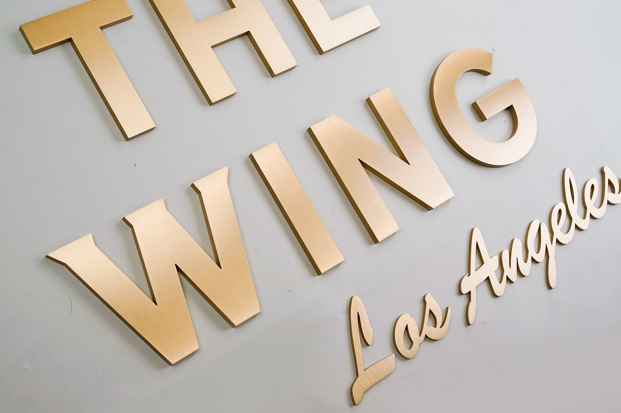 Retro, brass colored sign made from brushed, solid bronze for The Wing, a co-working space in Los Angeles. Retro, brass colored sign made from brushed, solid bronze for The Wing, a co-working space in Los Angeles.