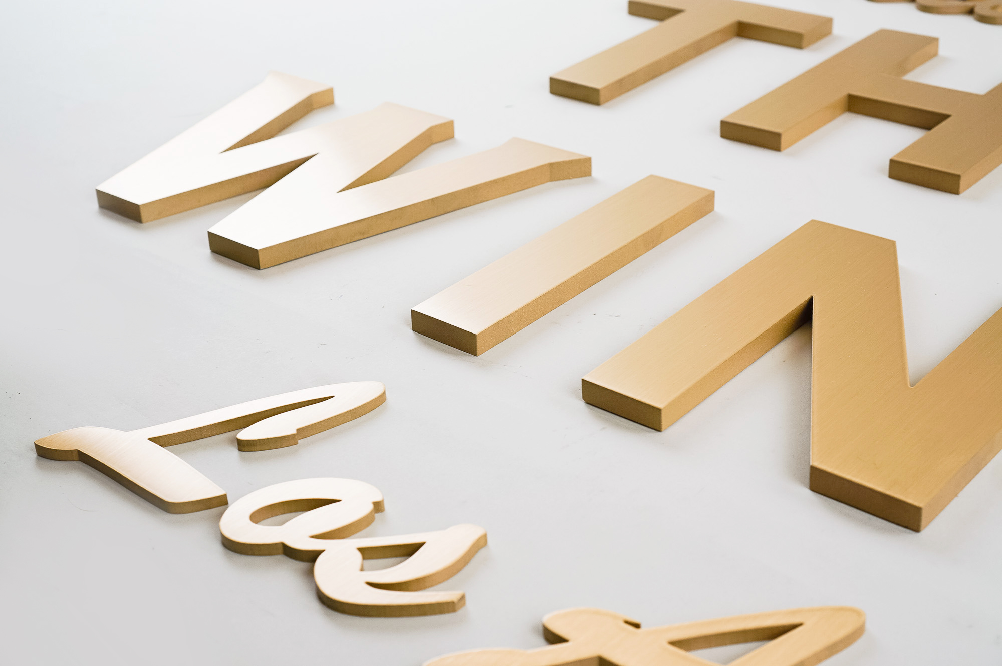 Retro, brass colored sign made from brushed, solid bronze for The Wing, a co-working space in Los Angeles. Retro, brass colored sign made from brushed, solid bronze for The Wing, a co-working space in Los Angeles.