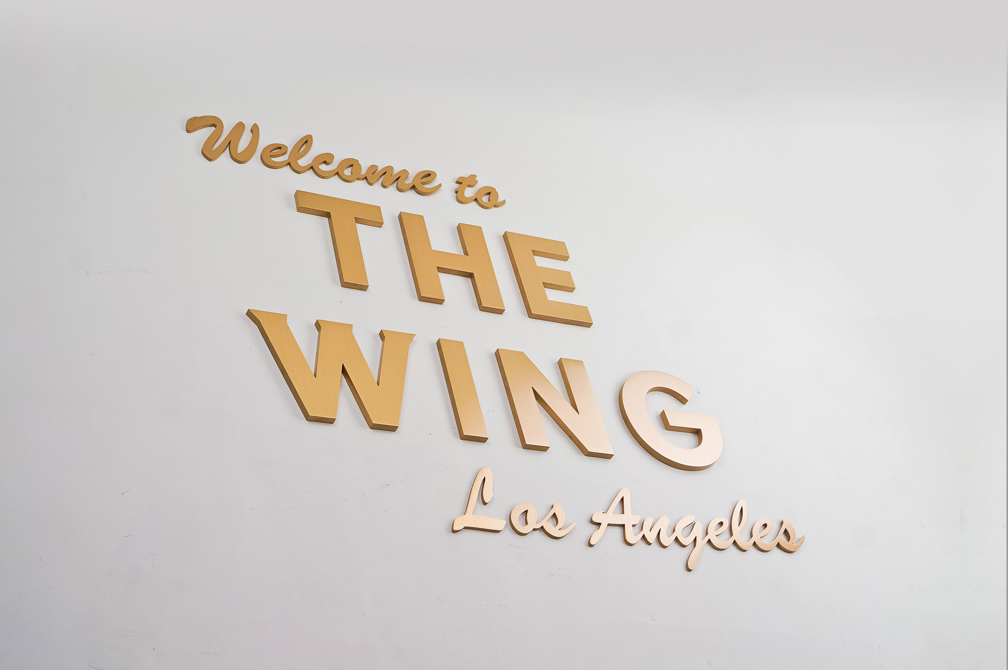 Retro, brass colored sign made from brushed, solid bronze for The Wing, a co-working space in Los Angeles. Retro, brass colored sign made from brushed, solid bronze for The Wing, a co-working space in Los Angeles.