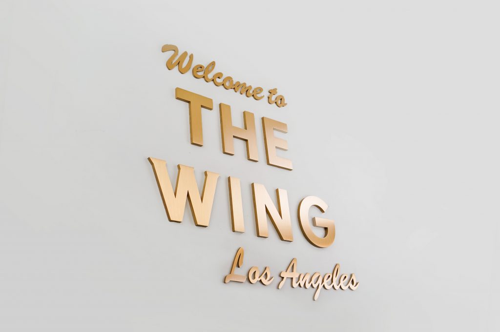 Retro, brass colored sign made from brushed, solid bronze for The Wing, a co-working space in Los Angeles.