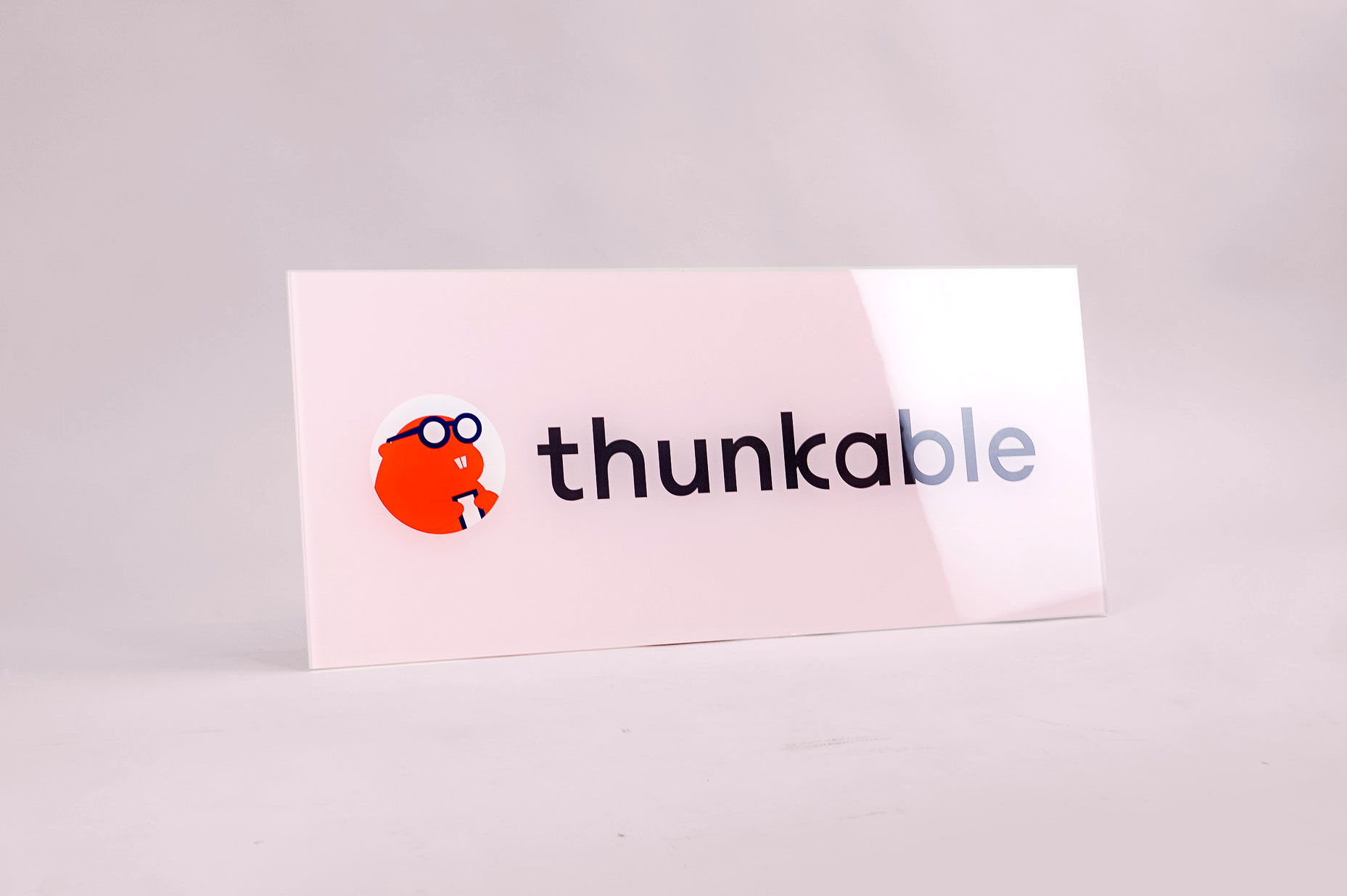 Glass-like, pink back printed sign for Thunkable, a cross-platform app builder that enables anyone to build their own native mobile apps. Glass-like, pink back printed sign for Thunkable, a cross-platform app builder that enables anyone to build their own native mobile apps.
