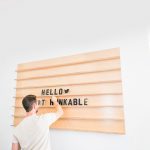 Wood message board with rails and clear letters for the office of Thunkable, a cross-platform app builder that enables anyone to build their own native mobile apps.