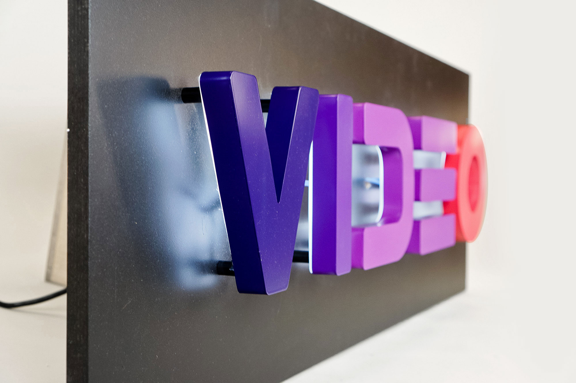 Halo-lit, retro-style, portable “VIDEO” sign with gradient for Facebook, an American online social media and social networking service company. Halo-lit, retro-style, portable