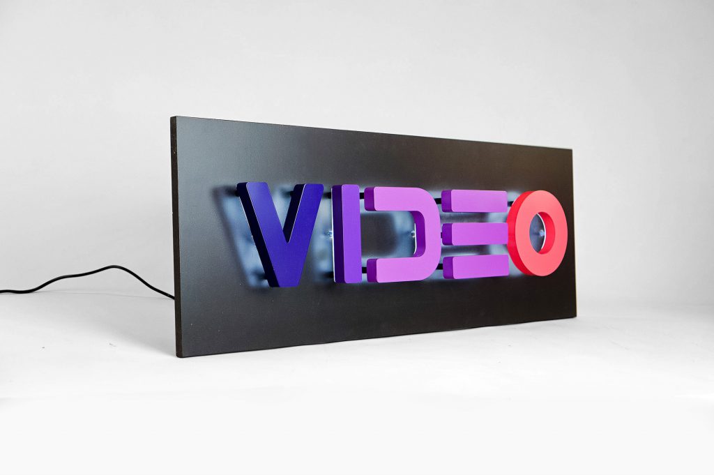 Halo-lit, retro-style, portable "VIDEO" sign with gradient for Facebook, an American online social media and social networking service company.