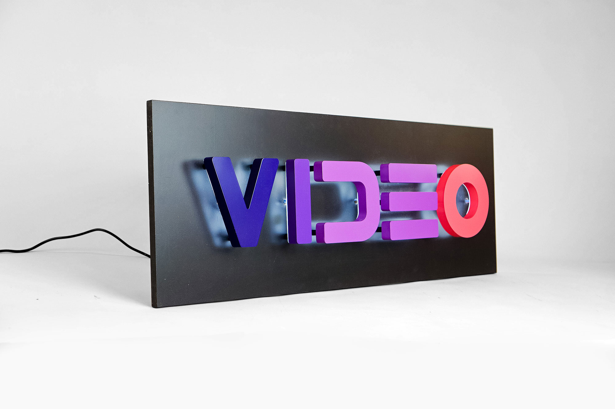 Halo-lit, retro-style, portable “VIDEO” sign with gradient for Facebook, an American online social media and social networking service company. Halo-lit, retro-style, portable