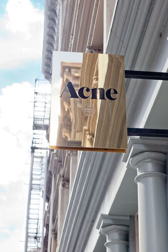 high gloss polished brass blade sign on building