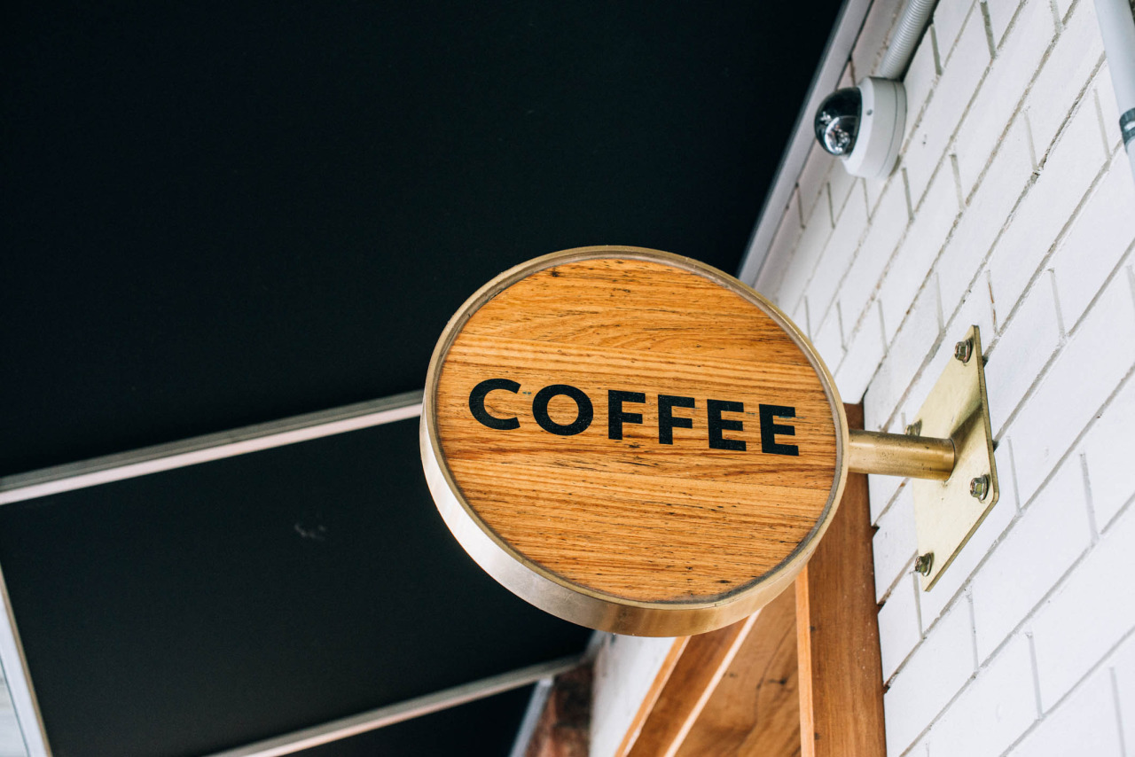 brass and wood cafe sign