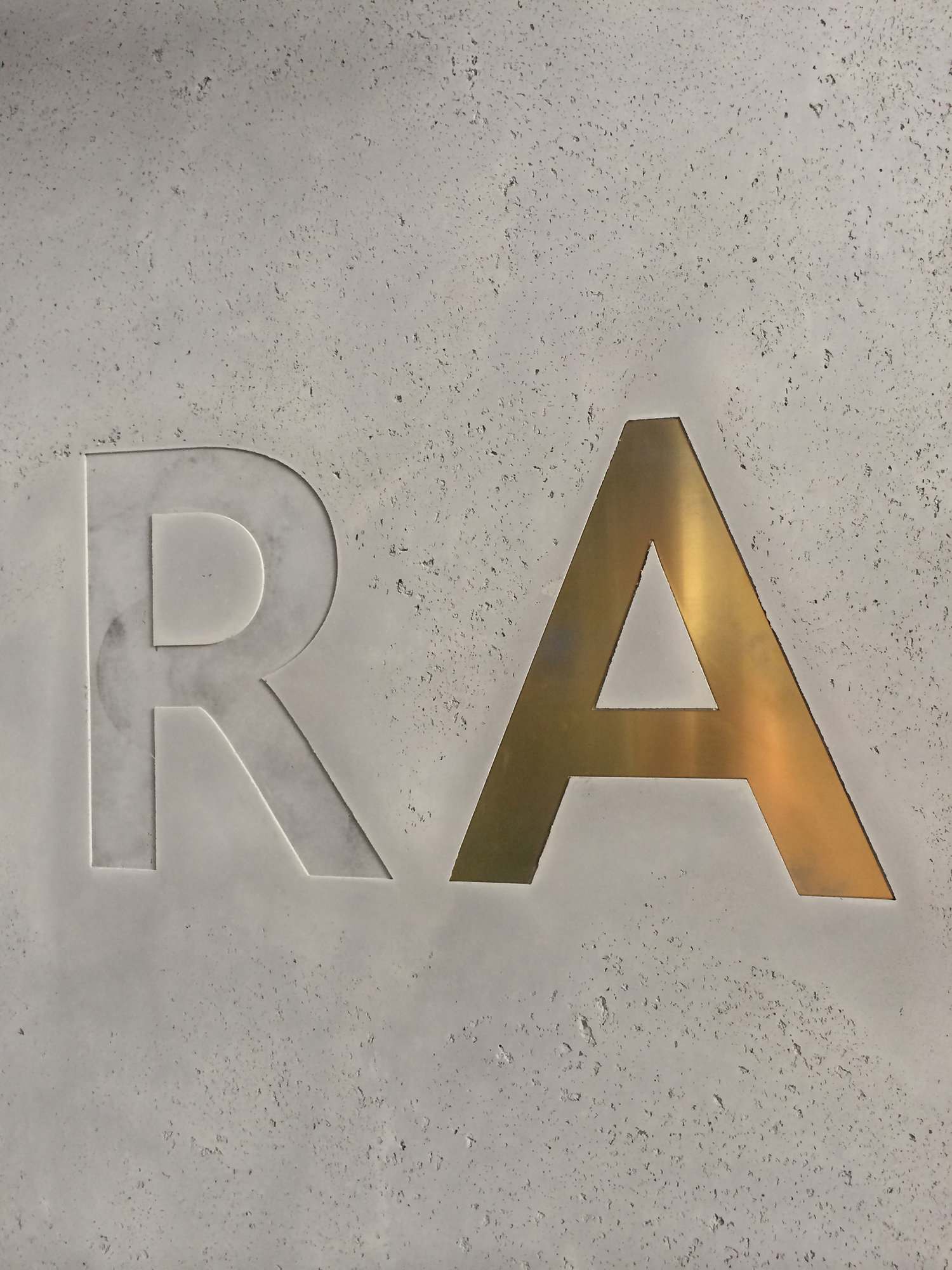 brass inlay letter on concrete