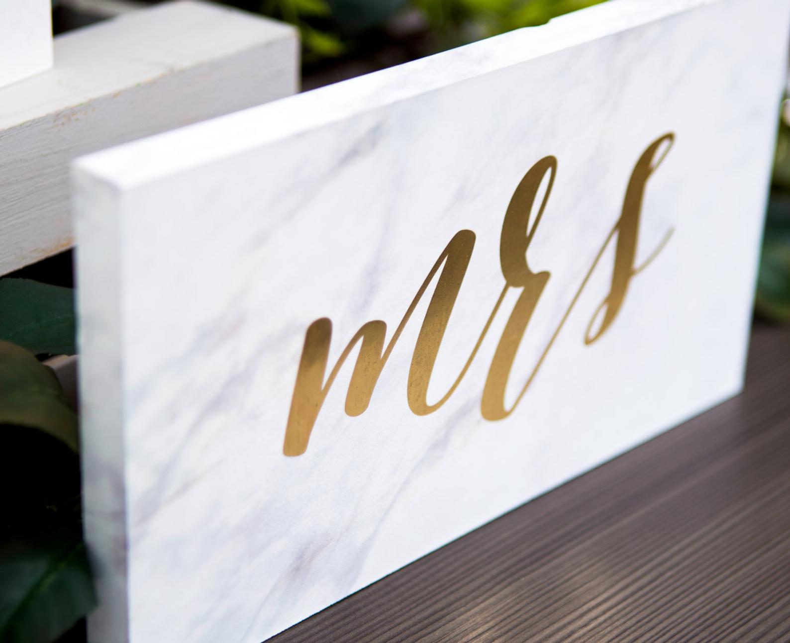 gold script on marble sign
