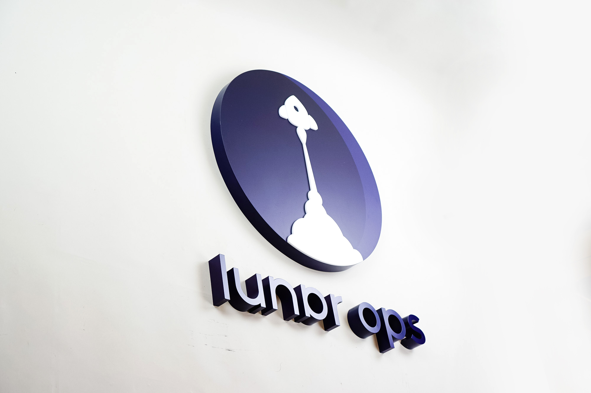 Dimensional purple letters and white rocket ship for Lunar Ops, Inc. in New York. Dimensional purple letters and white rocket ship for Lunar Ops, Inc. in New York.