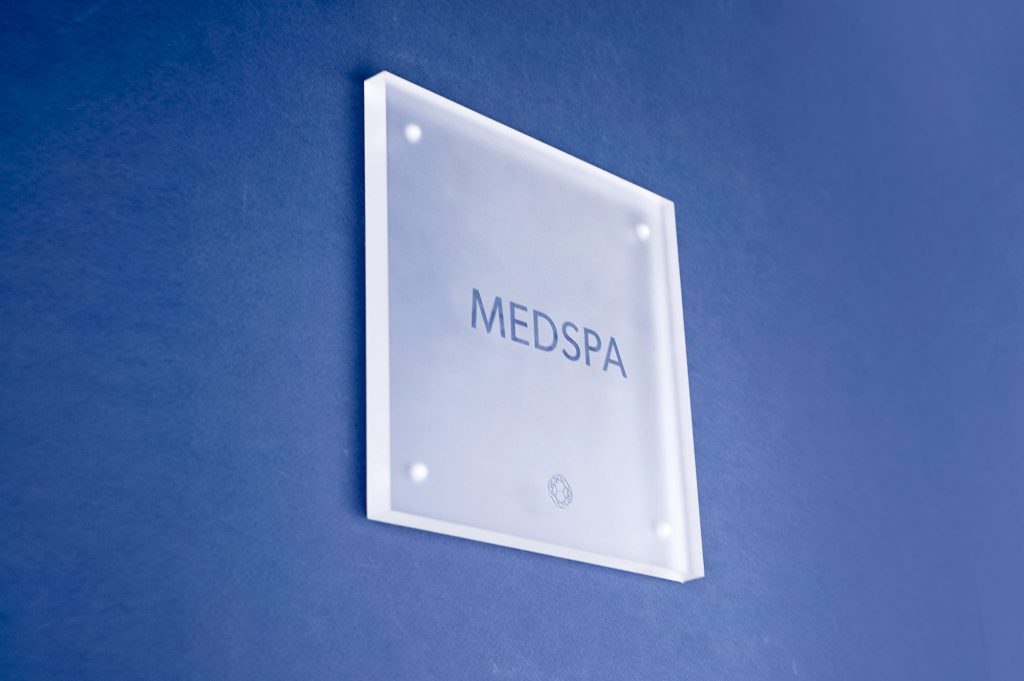 Frosted room sign with glossy clear ink for Nexus Club, Nexus Club, a private social and business club in New York.