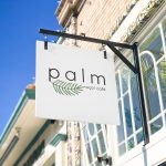 Simple white blade sign for palm acai cafe in Oakland, CA