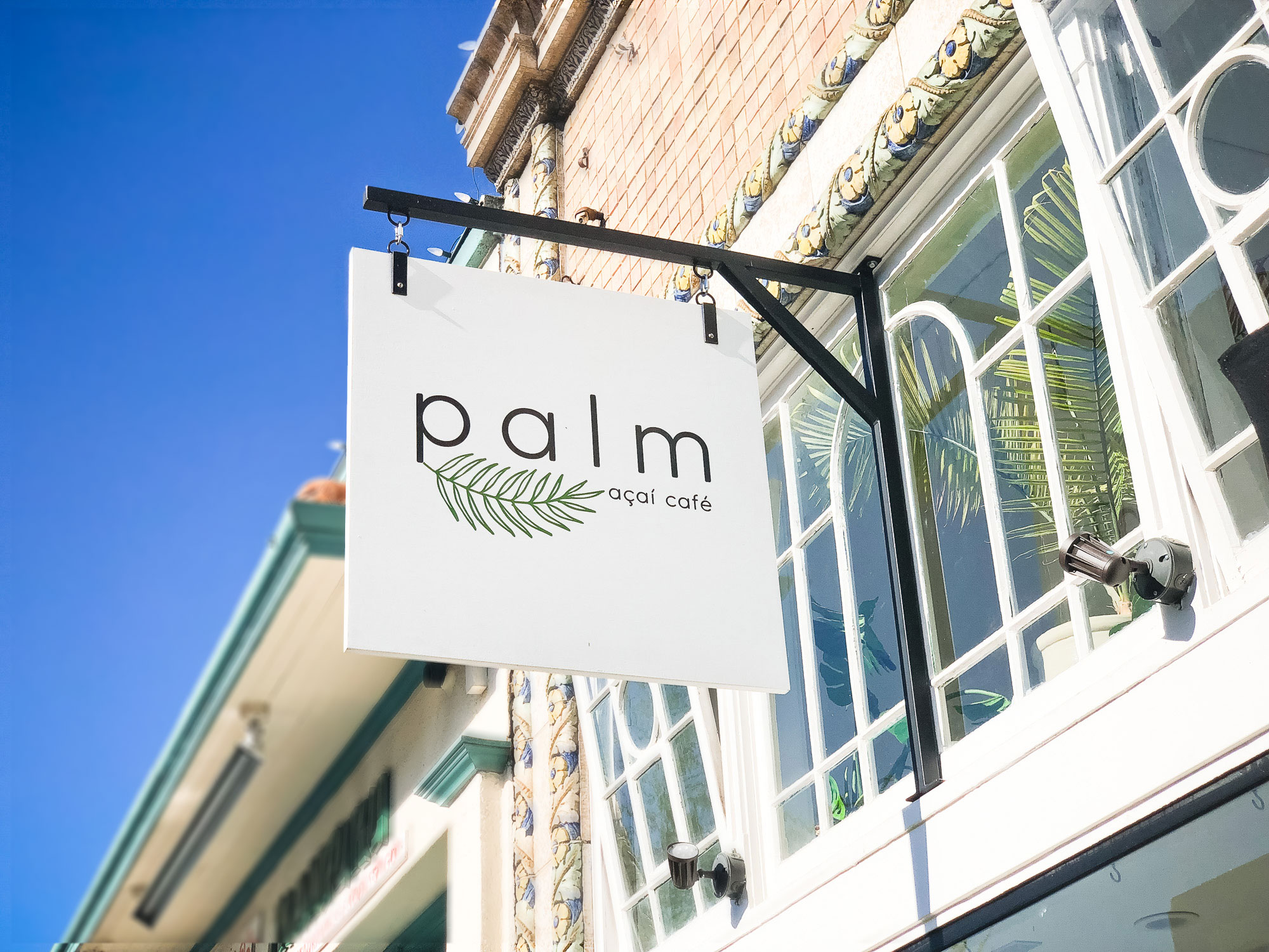Simple white blade sign for palm acai cafe in Oakland, CA Simple white blade sign for palm acai cafe in Oakland, CA