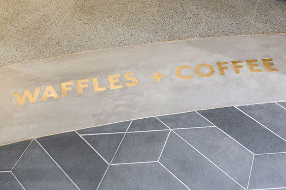 brass letters inlaid on a concrete floor