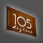 Rusted metal illuminated sign for 105 Degrees, a hot yoga studio at Newtown Athletic Club, a premiere family fitness and wellness center serving residents of Newtown, PA