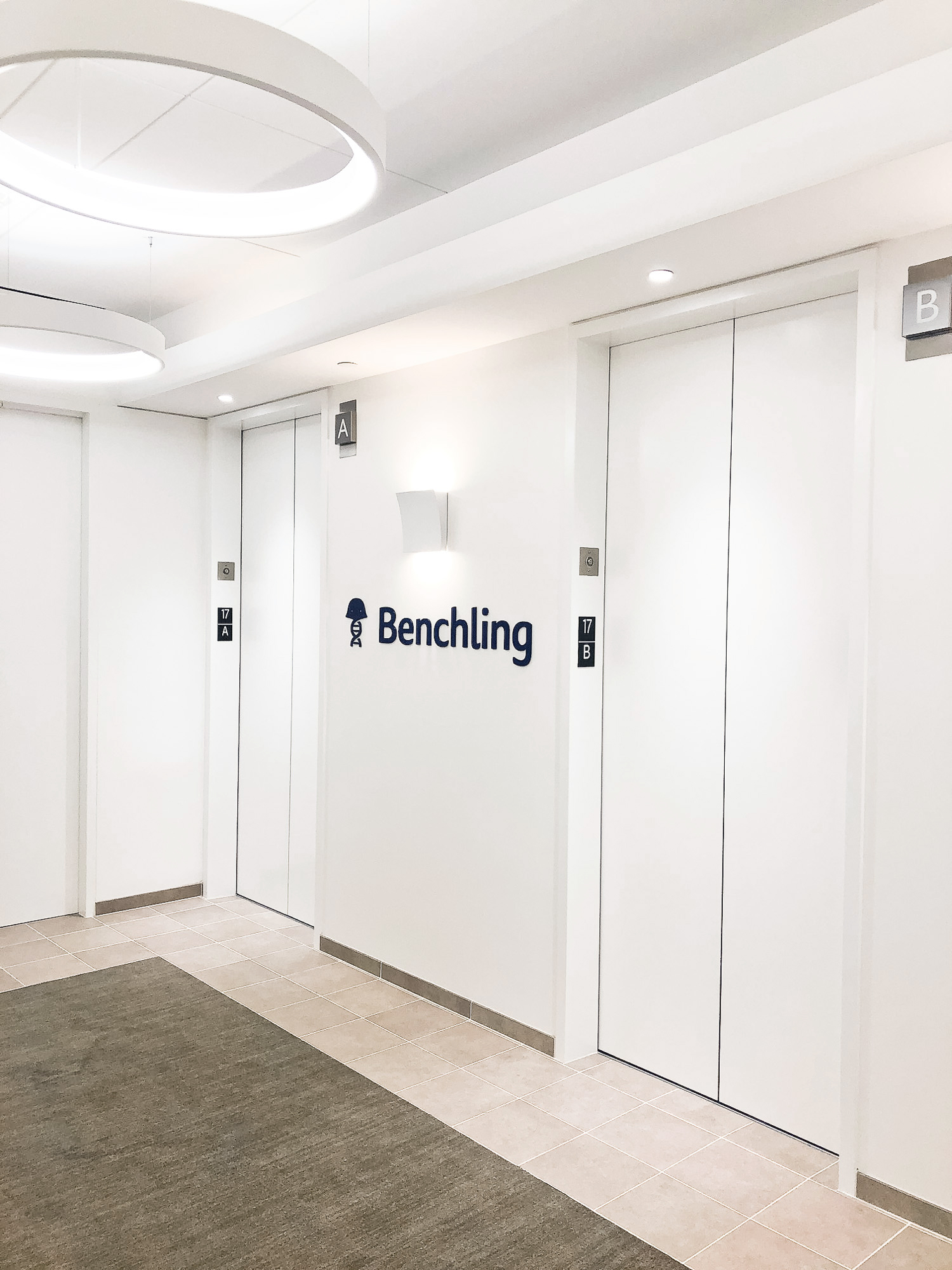 Navy blue sign on white wall in the elevator vestibule of Benchling, a San Francisco based company working on a unified platform to accelerate, measure, and forecast R&D from discovery through bioprocessing. Navy blue sign on white wall in the elevator vestibule of Benchling, a San Francisco based company working on a unified platform to accelerate, measure, and forecast R&D from discovery through bioprocessing.