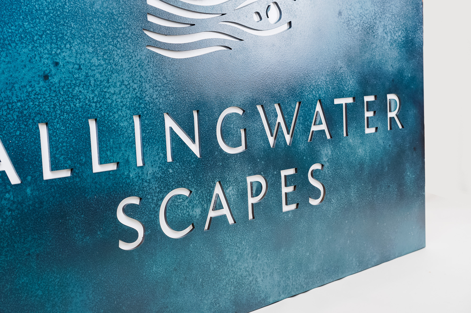 Blue-hued, rusted bronze/brass/copper patina style sign for FallingWater Scapes, a water feature design, construction and maintenance company in Dover, MA. Blue-hued, rusted bronze/brass/copper patina style sign for FallingWater Scapes, a water feature design, construction and maintenance company in Dover, MA.