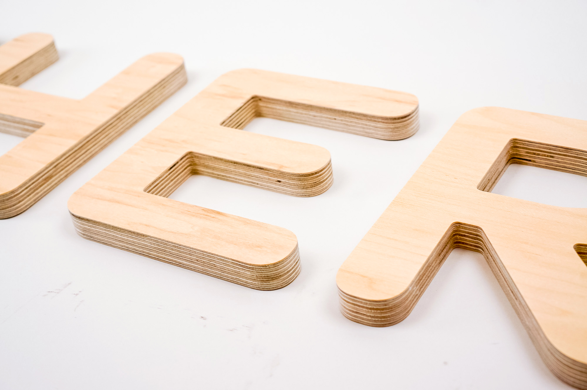 CNC routed plywood letters for Feather, furniture renting service.