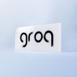 Glassy black and white sign with black brushstroke logo for Groq, a Palo Alto based company developing an integrated circuit developed specifically for machine learning.