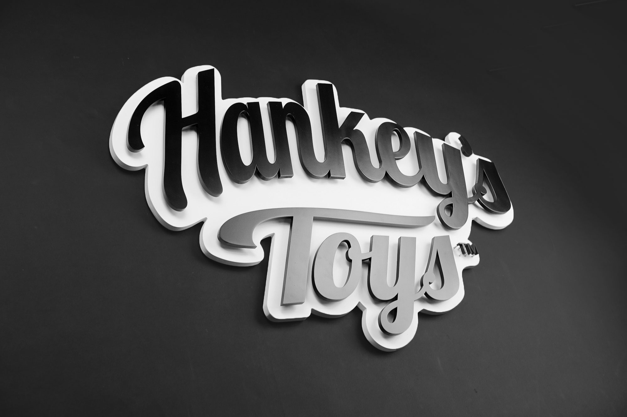 Black and white raised cutout script logo for Mr. Hankey’s Toys, maker of handmade adult sex toys. Black and white raised cutout script logo for Mr. Hankey's Toys, maker of handmade adult sex toys.