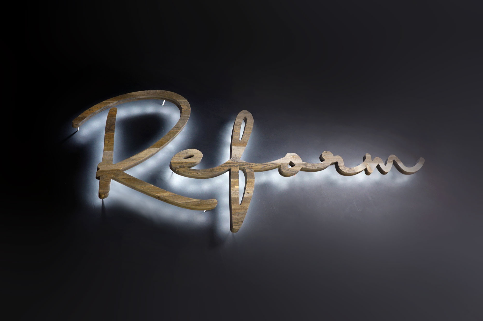 Reclaimed wood illuminated script sign for Reform, a fitness studio at Newtown Athletic Club, a premiere family fitness and wellness center serving residents of Newtown, PA Reclaimed wood illuminated script sign for Reform, a fitness studio at Newtown Athletic Club, a premiere family fitness and wellness center serving residents of Newtown, PA