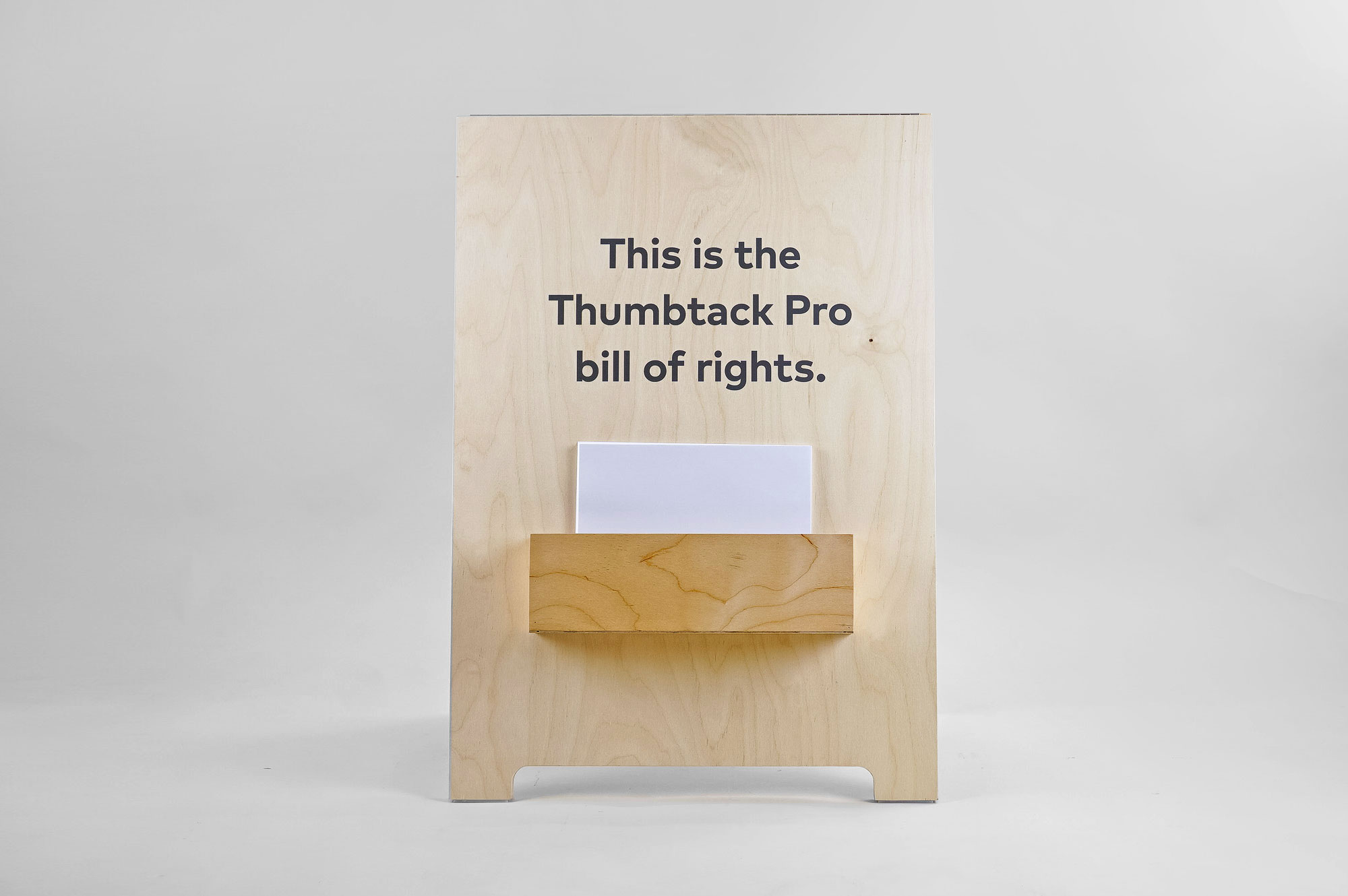 Light wood a-frame with brochure pocket for Thumbtack, an online service that matches customers with local professionals.