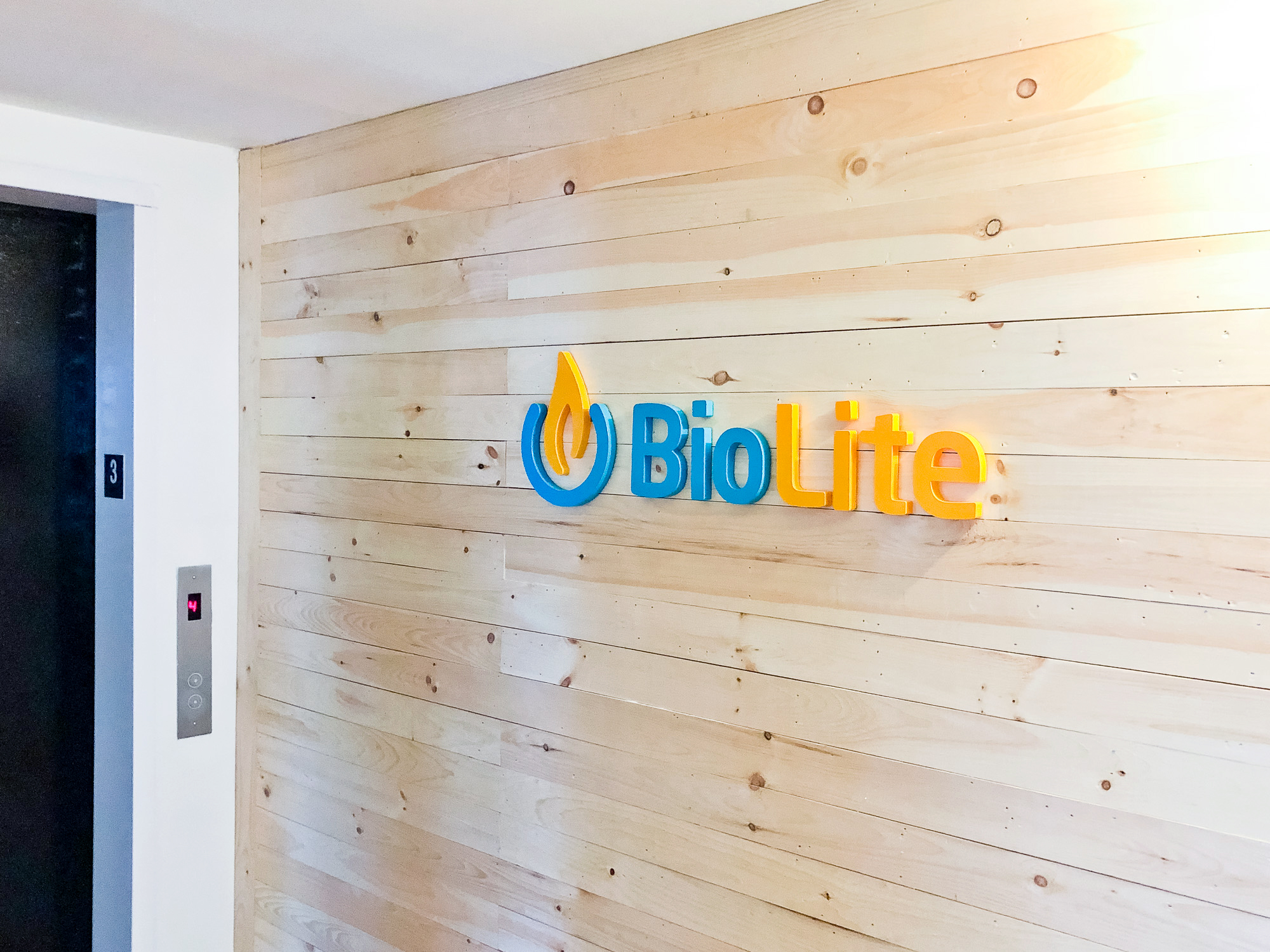 Colored logo on light wood slat wall for Biolite, a New York City based startup that develops and manufactures off-grid energy products for both the outdoor recreational industry and emerging markets.