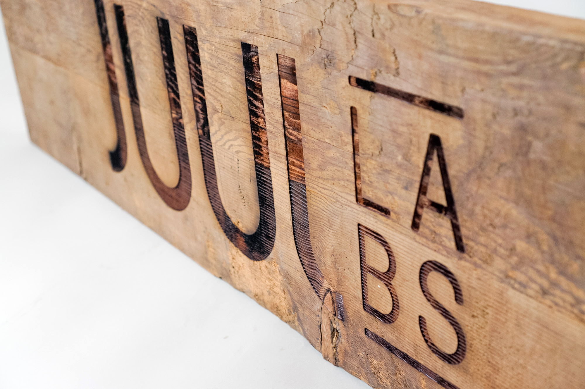 Reclaimed wood sign with etched logo for the San Francisco office of Juul, an electronic cigarette company. Reclaimed wood sign with etched logo for the San Francisco office of Juul, an electronic cigarette company.