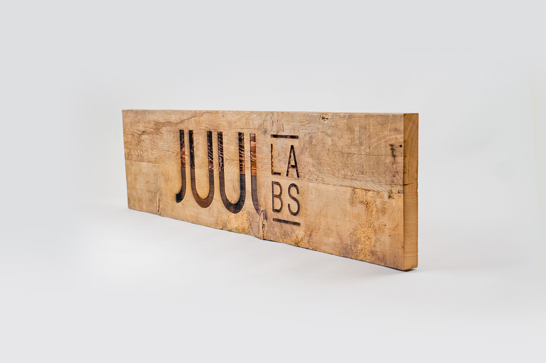 Reclaimed wood sign with etched logo for the San Francisco office of Juul, an electronic cigarette company. Reclaimed wood sign with etched logo for the San Francisco office of Juul, an electronic cigarette company.