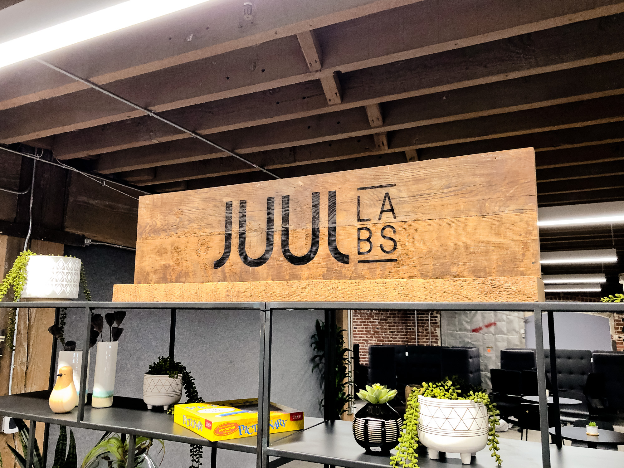Reclaimed wood sign with etched logo on a shelf for the San Francisco office of Juul, an electronic cigarette company. Reclaimed wood sign with etched logo on a shelf for the San Francisco office of Juul, an electronic cigarette company.