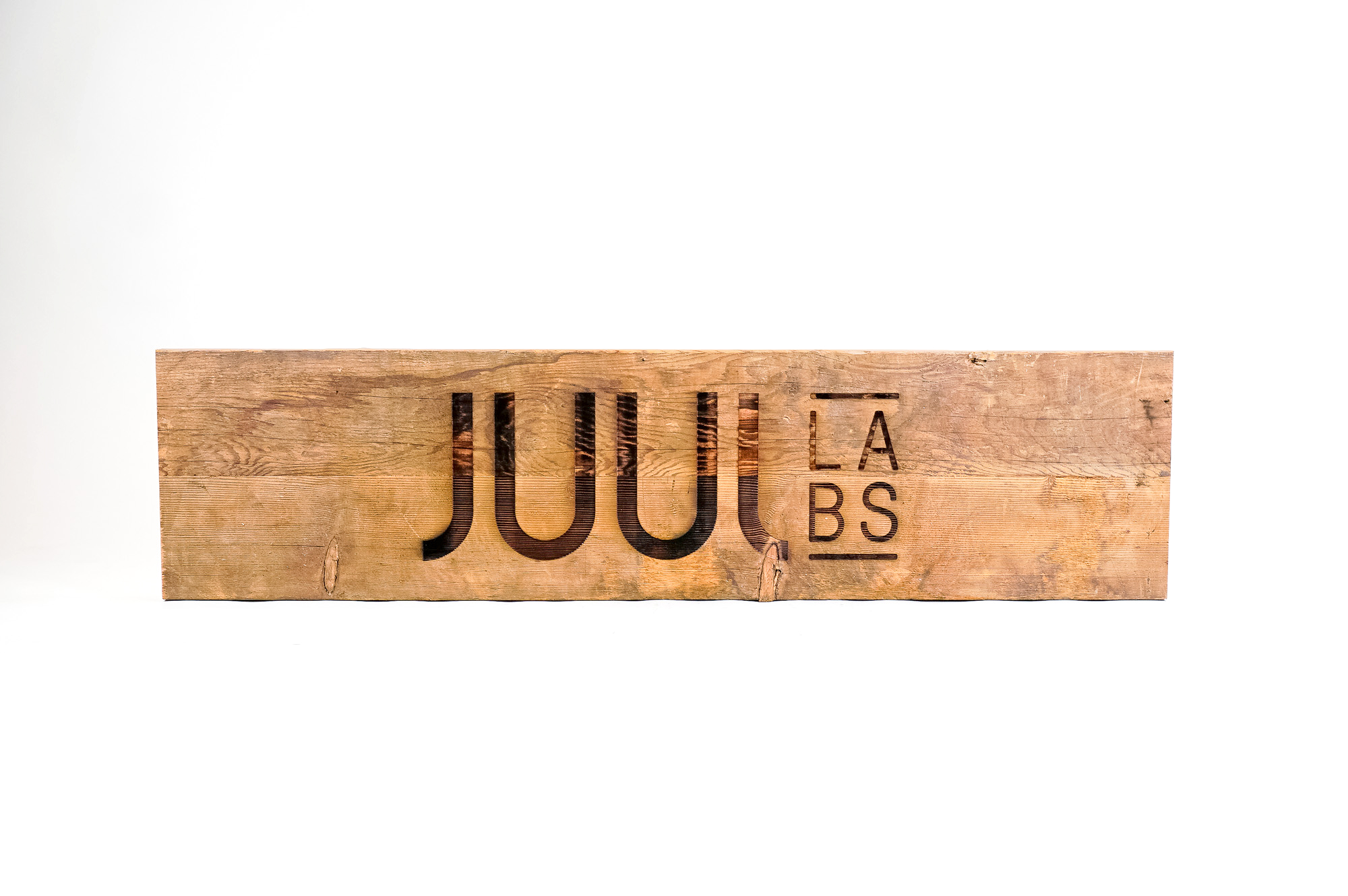 Reclaimed wood sign with etched logo for the San Francisco office of Juul, an electronic cigarette company. Reclaimed wood sign with etched logo for the San Francisco office of Juul, an electronic cigarette company.
