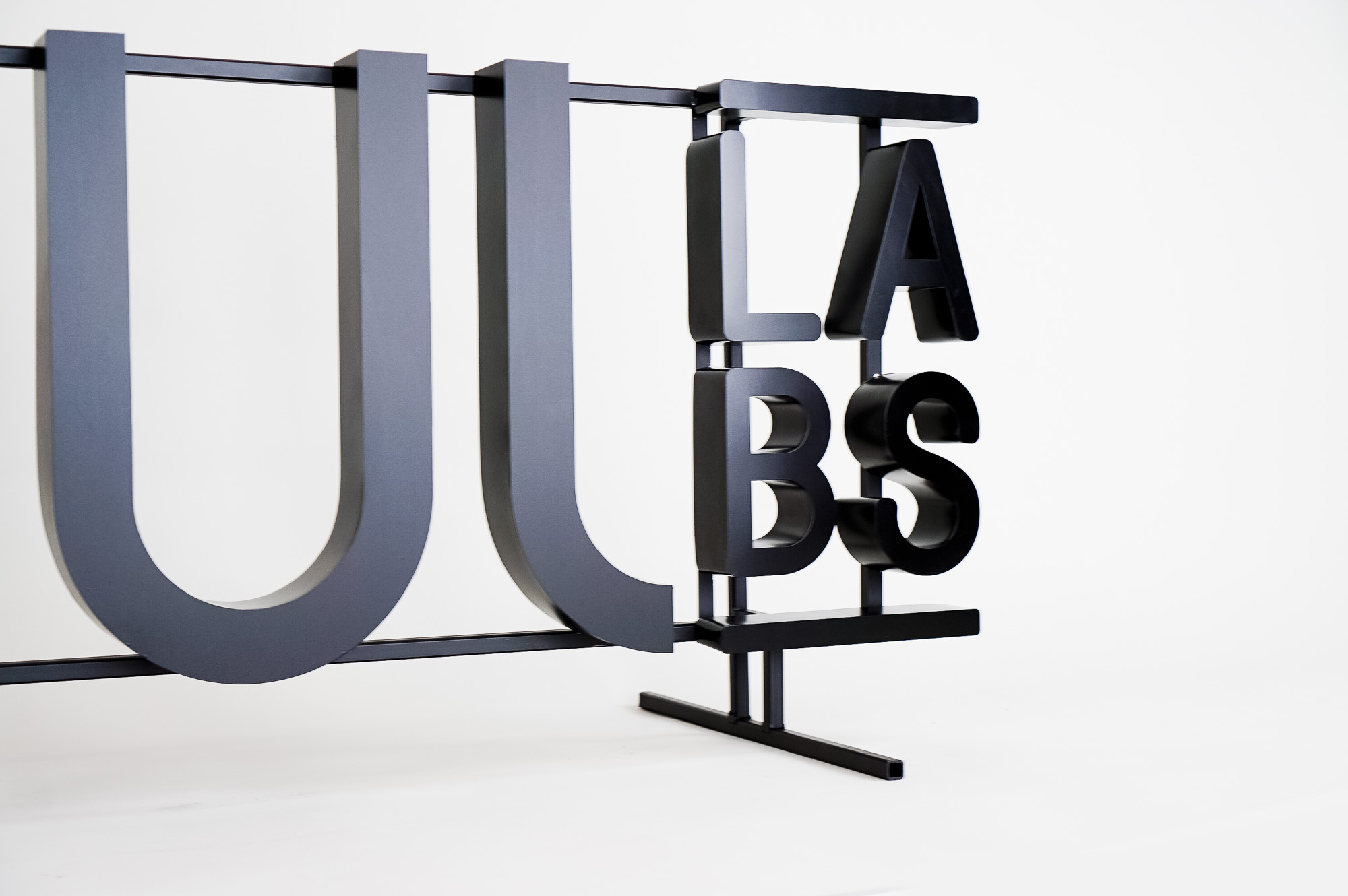 Black metal floating letter shelf sign for the San Francisco office of Juul, an electronic cigarette company. Black metal floating letter shelf sign for the San Francisco office of Juul, an electronic cigarette company.