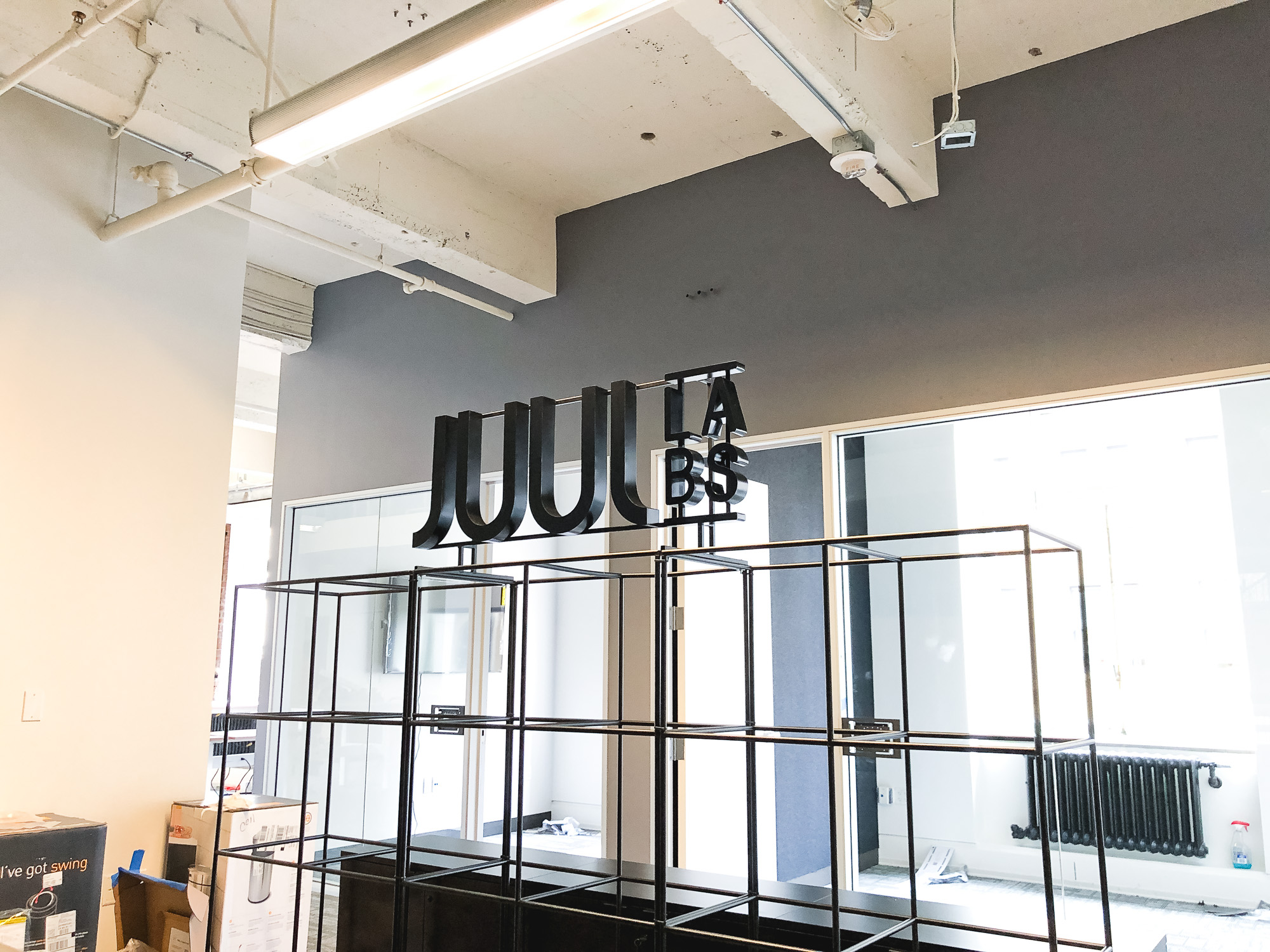 Black metal floating letter shelf sign for the San Francisco office of Juul, an electronic cigarette company. Black metal floating letter shelf sign for the San Francisco office of Juul, an electronic cigarette company.